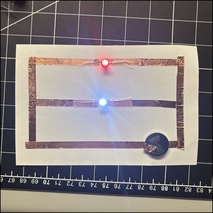 This is a picture of the series circuit taken after I light up the LEDs. Some of the tape overlapped leading to some errors.