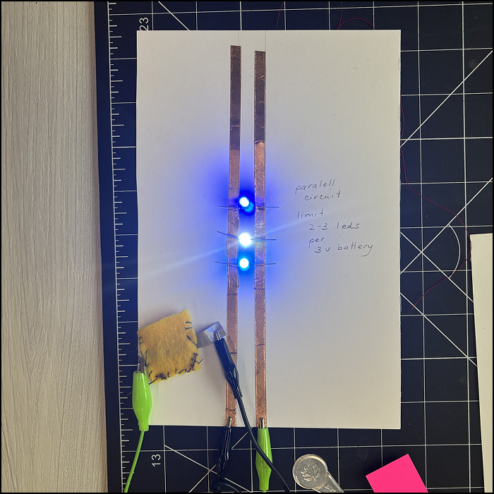 Using a parallel circuit provided in class, I experimented with the sewed button with alligator clips.