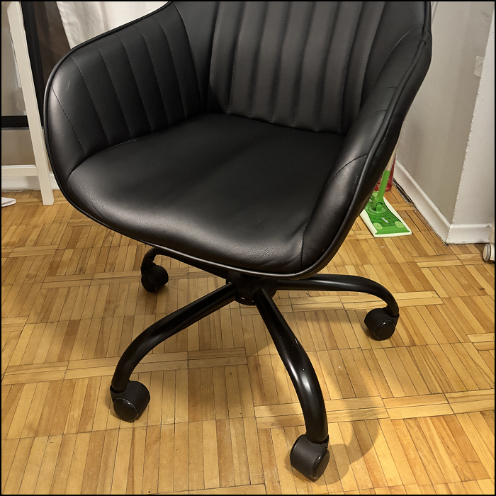 The sound of moving a chair with wheels.