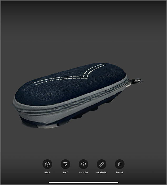 A 3D scan of my eyeglass case. Scaniverse was able to capture its texture very well, though the bottom seems to be stuck to the surface.